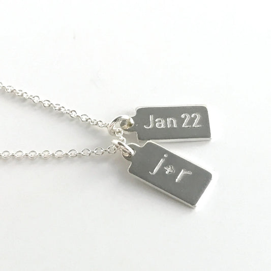 sterling silver dog tag necklace showing two tags with engraving