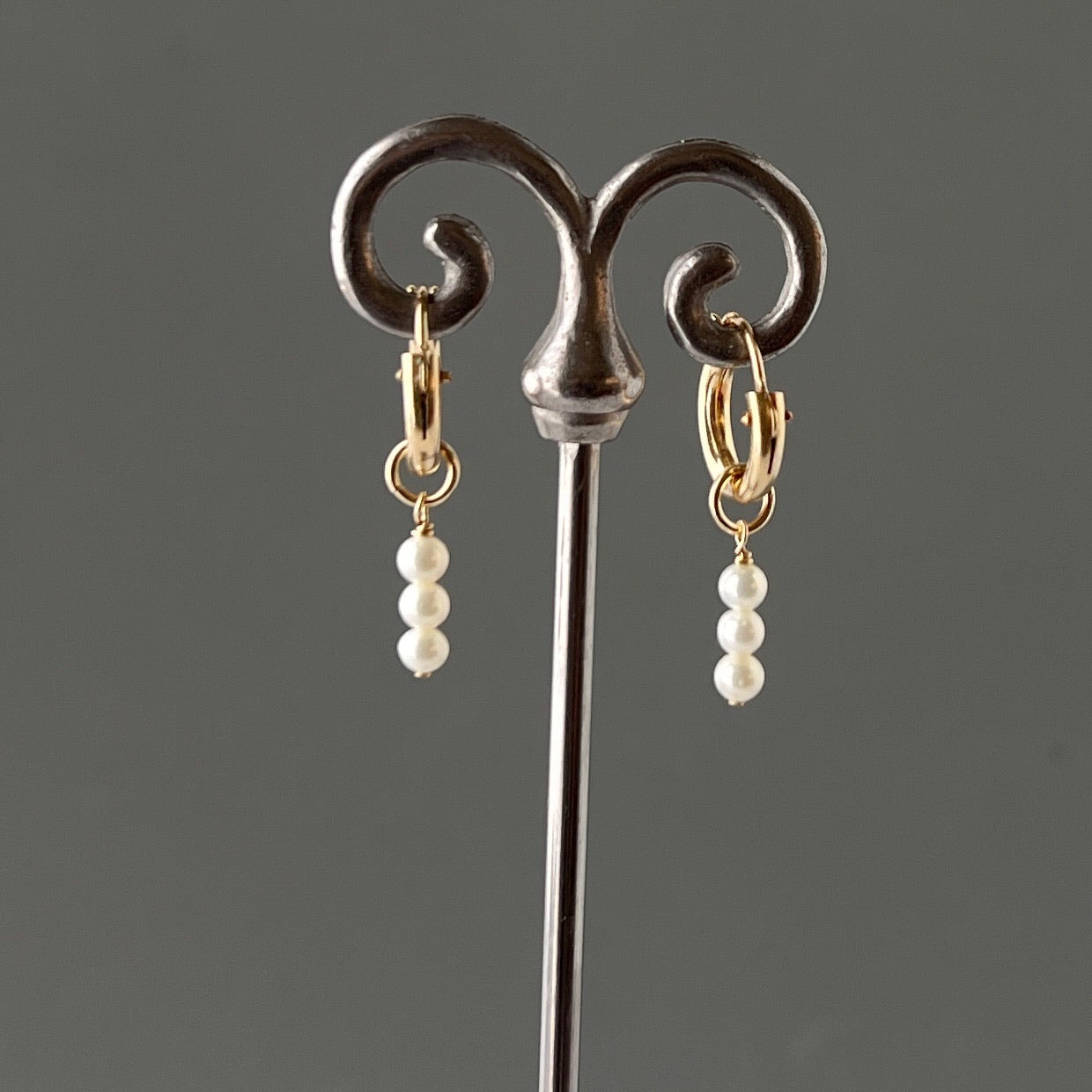 pearl hoop earrings on stand.  These dangling pearl drop earrings are available in 14k gold fill and sterling silver