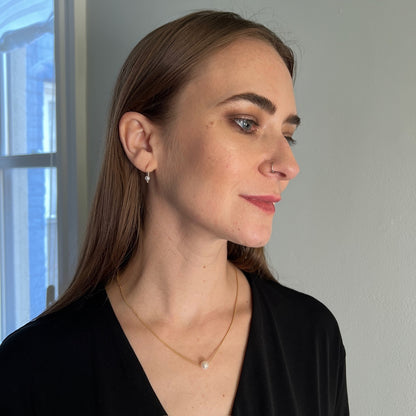 model wearing floating pearl necklace in gold