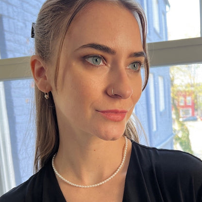 model wearing small pearl choker necklace