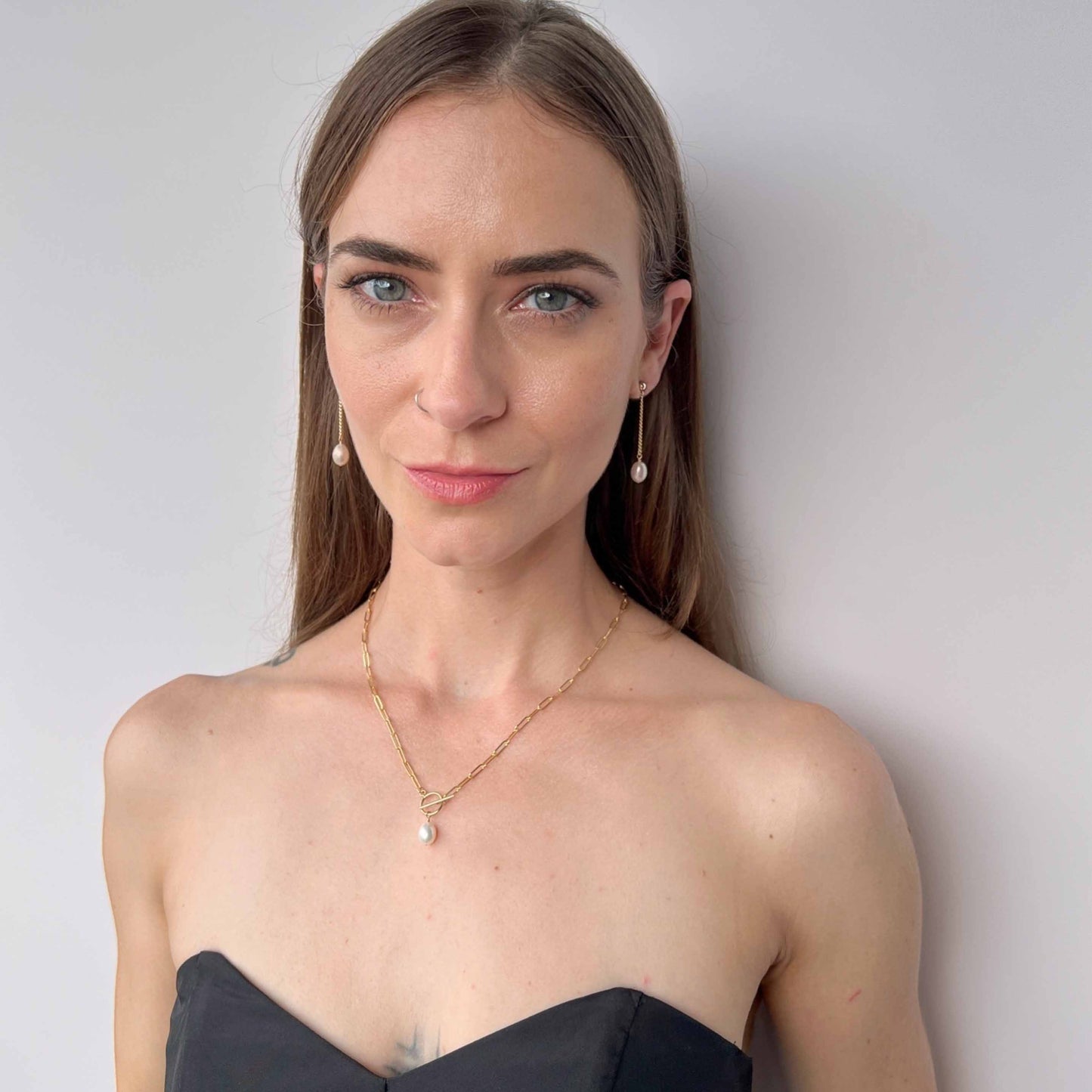 model wearing Nicola paperclip pearl necklace and matching Nicola earrings