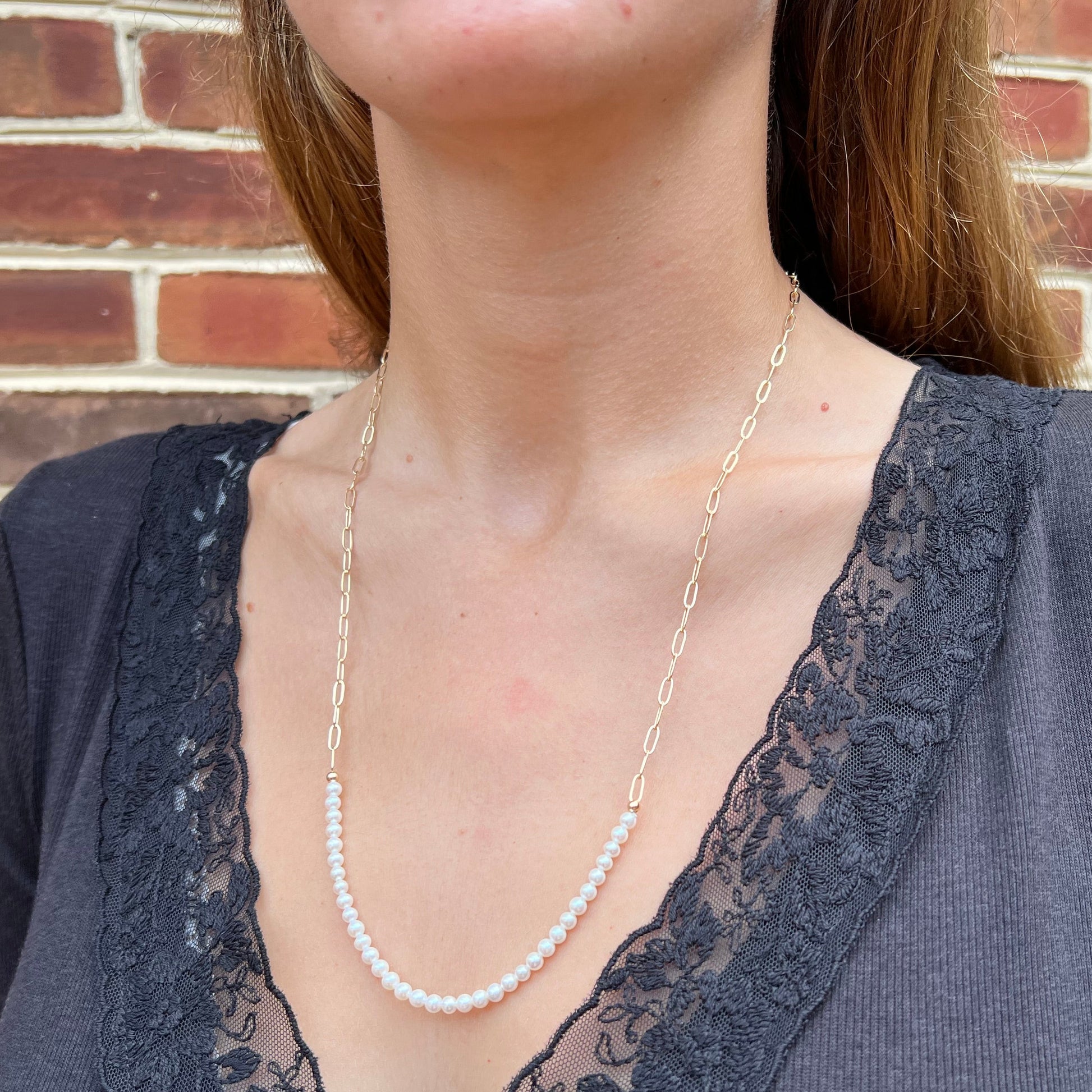 model wearing add a pearl look necklace with paperclip chain and small white freshwater pearls