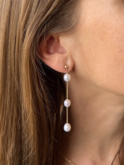 model close up of 14k gold filled stud earrings with long pearl dangles