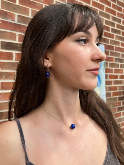 model wearing large lapis ball necklace and lapis ball hoop earrings with 14k gold filled chain and hoop earrings