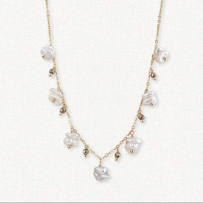 small organic keshi pearls alternate with tiny gold pyrite dangles on this 14k gold filled necklace