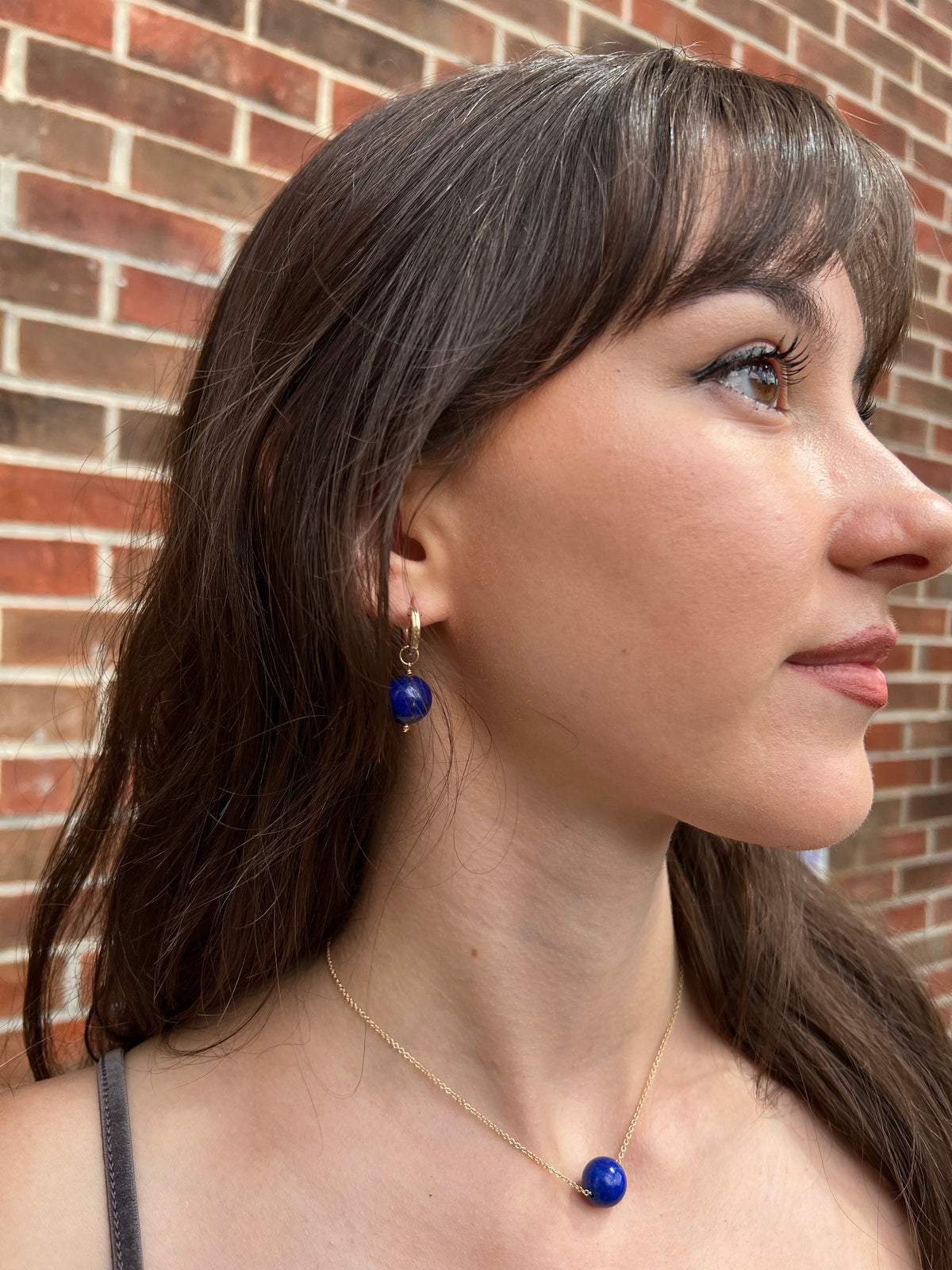 model with lapis necklace and matching hoop earrings