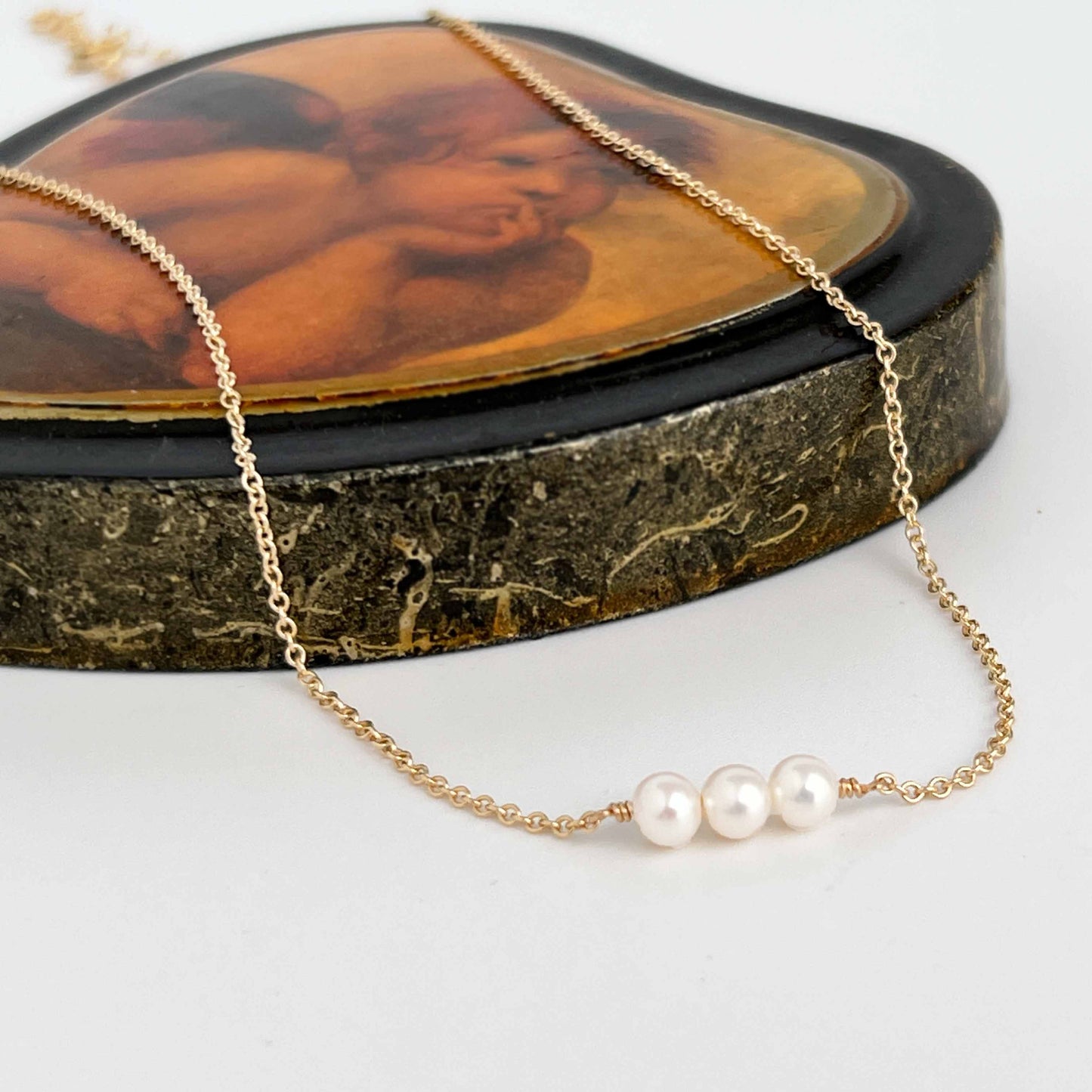 close up of Lucia dainty 3 pearl necklace