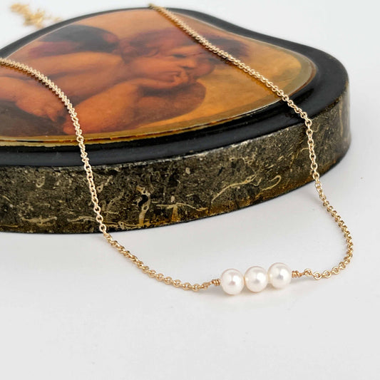 close up of Lucia dainty 3 pearl necklace