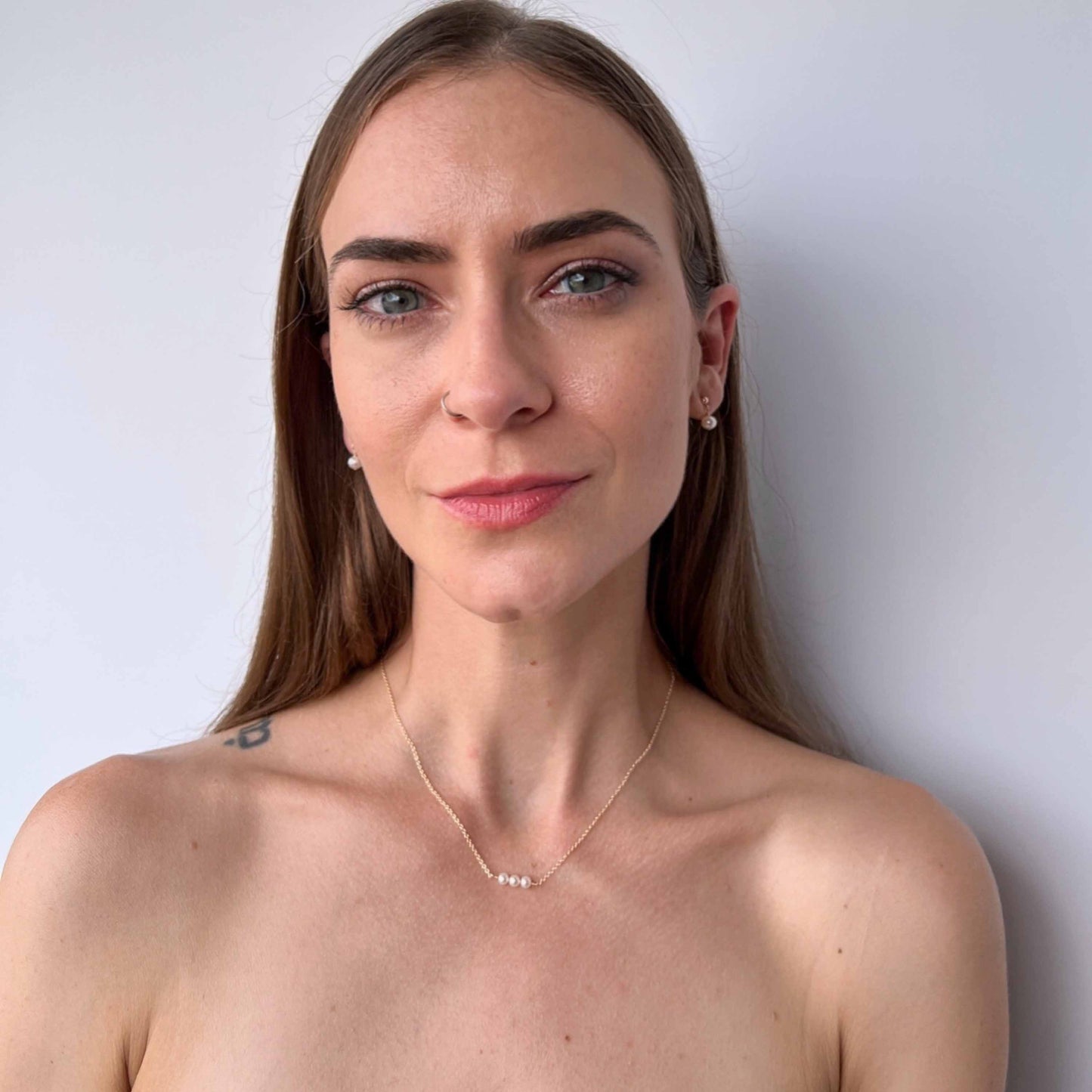model wearing necklace and earrings from Lucia collection