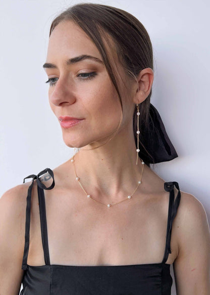 model wearing a necklace and earring set from Lucia Collection