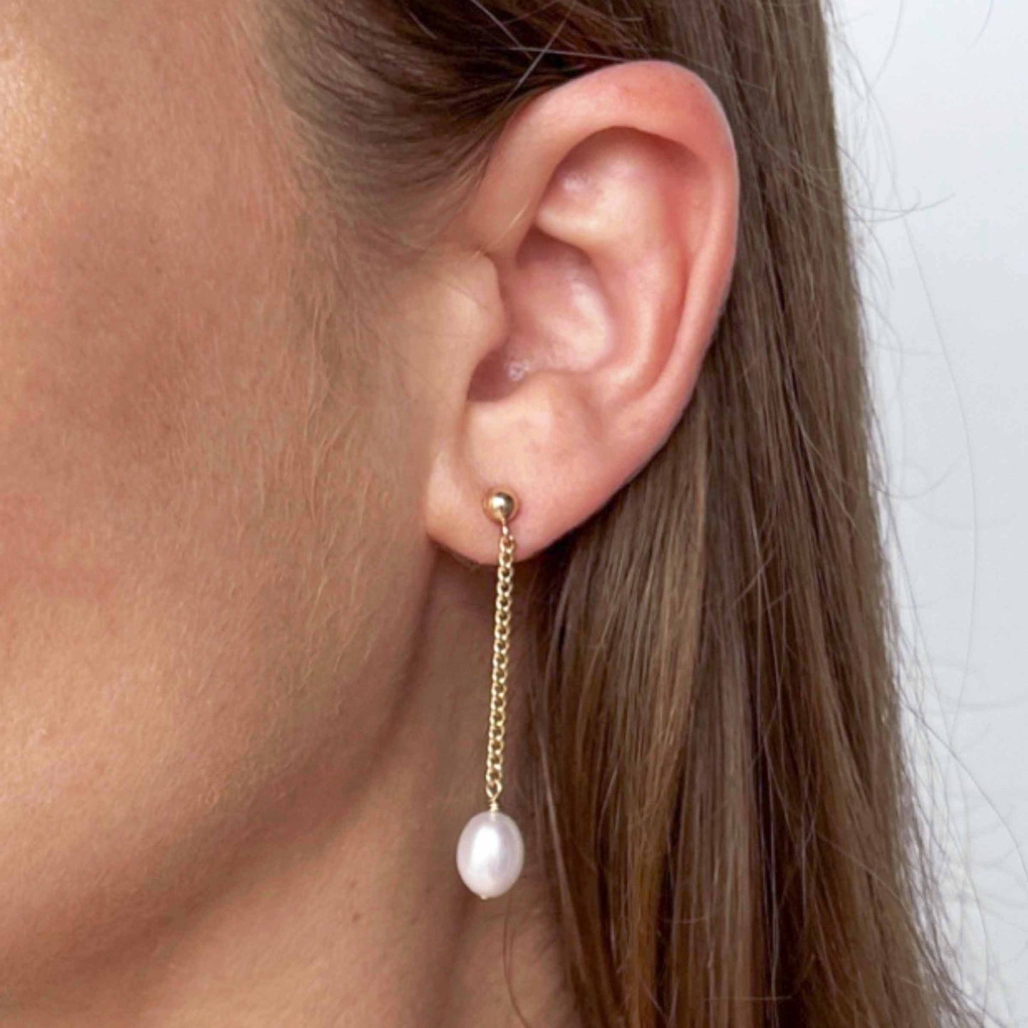 close up of model with Nicola Dangling Pearl Earrings