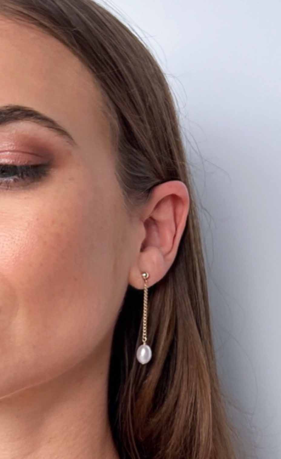 model wearing Nicola Long Dangle Pearl Earrings
