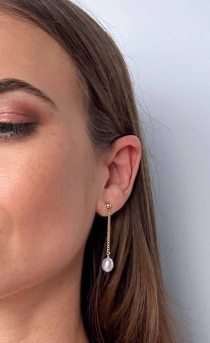model wearing Nicola Long Dangle Pearl Earrings