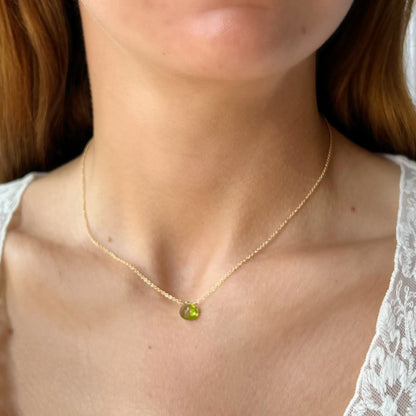 close up of peridot briolette on cable chain on model
