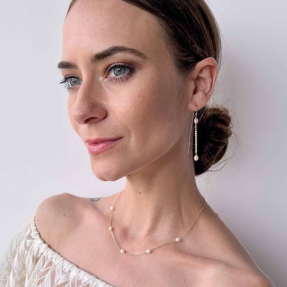 model wearing pearl station necklace from Rosa collection