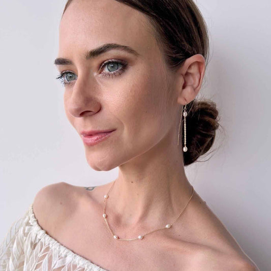 model wearing pearl station necklace from Rosa collection