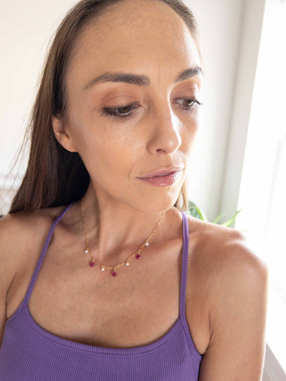 model wearing 16 inch ruby necklace with pearls