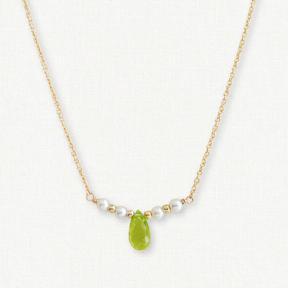 Dainty Pearl and Peridot Necklace on 14k gold filled chain.  Center peridot gemstone is teardrop shaped, surrounded by 4 tiny pearls and gold beads