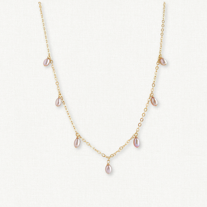 close up of pink blush pearl necklace dangling from 14k gold filled chain