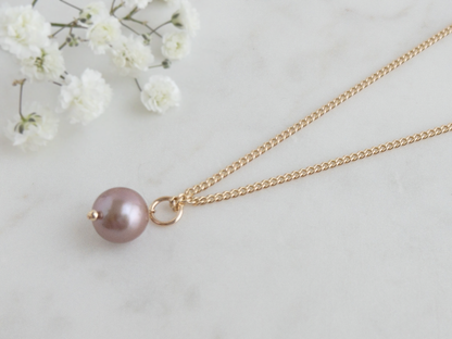 close up of edison pearl pendant on gold curb chain.  large pearl pendant