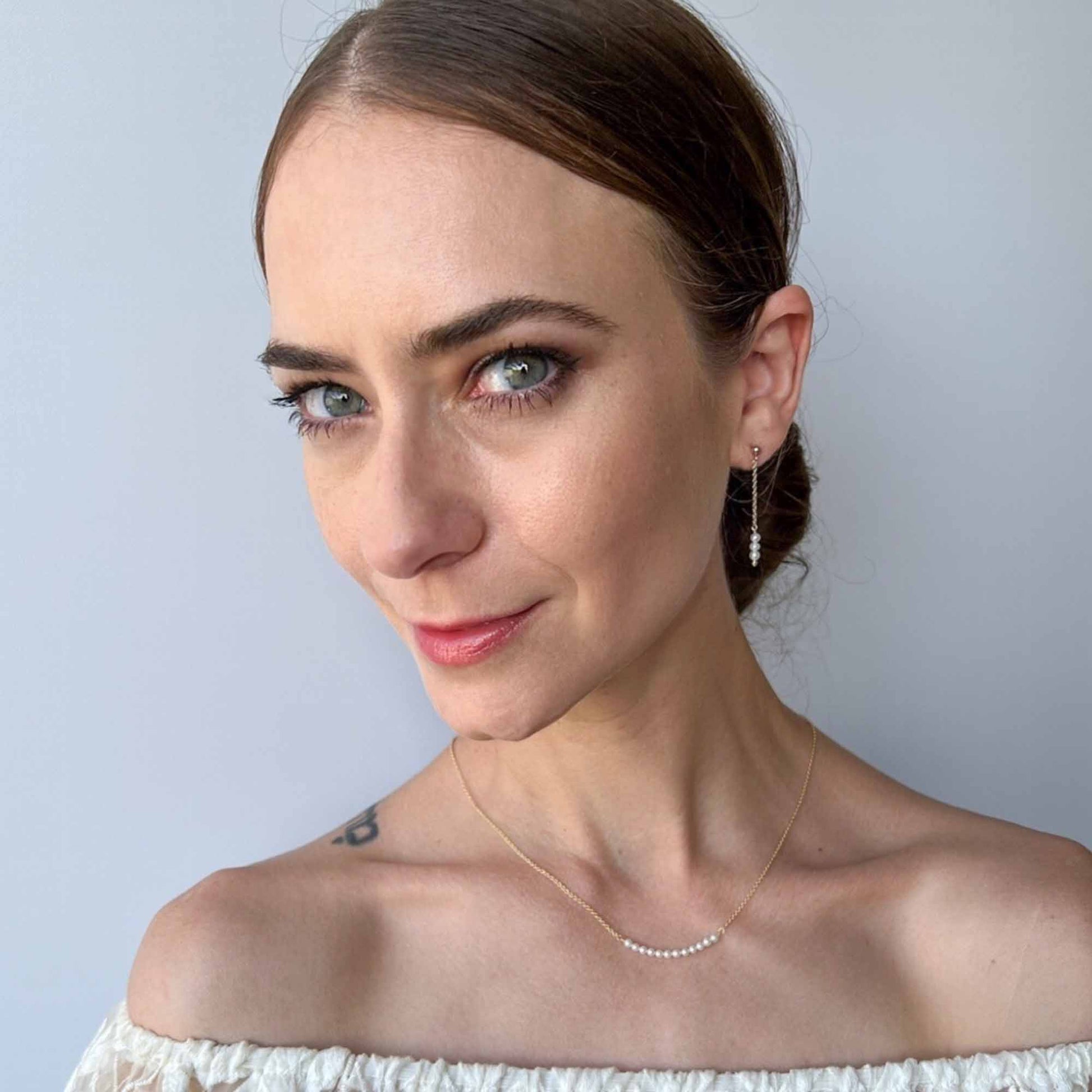 model wearing pearl stud earrings with 1.5 inch dangle.
