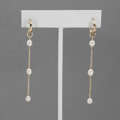 huggie hoop pearl earrings on earring stand