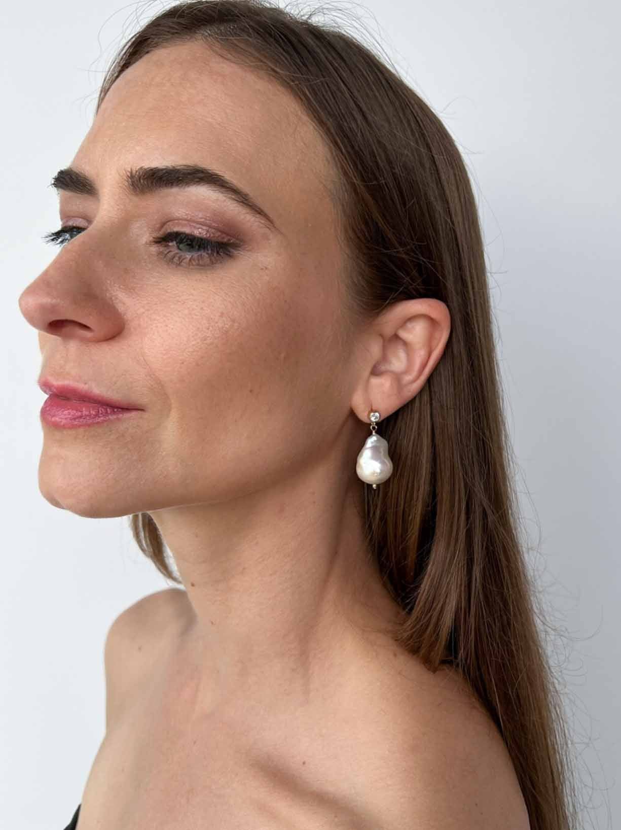 model wearing cz stud large baroque pearl earrings