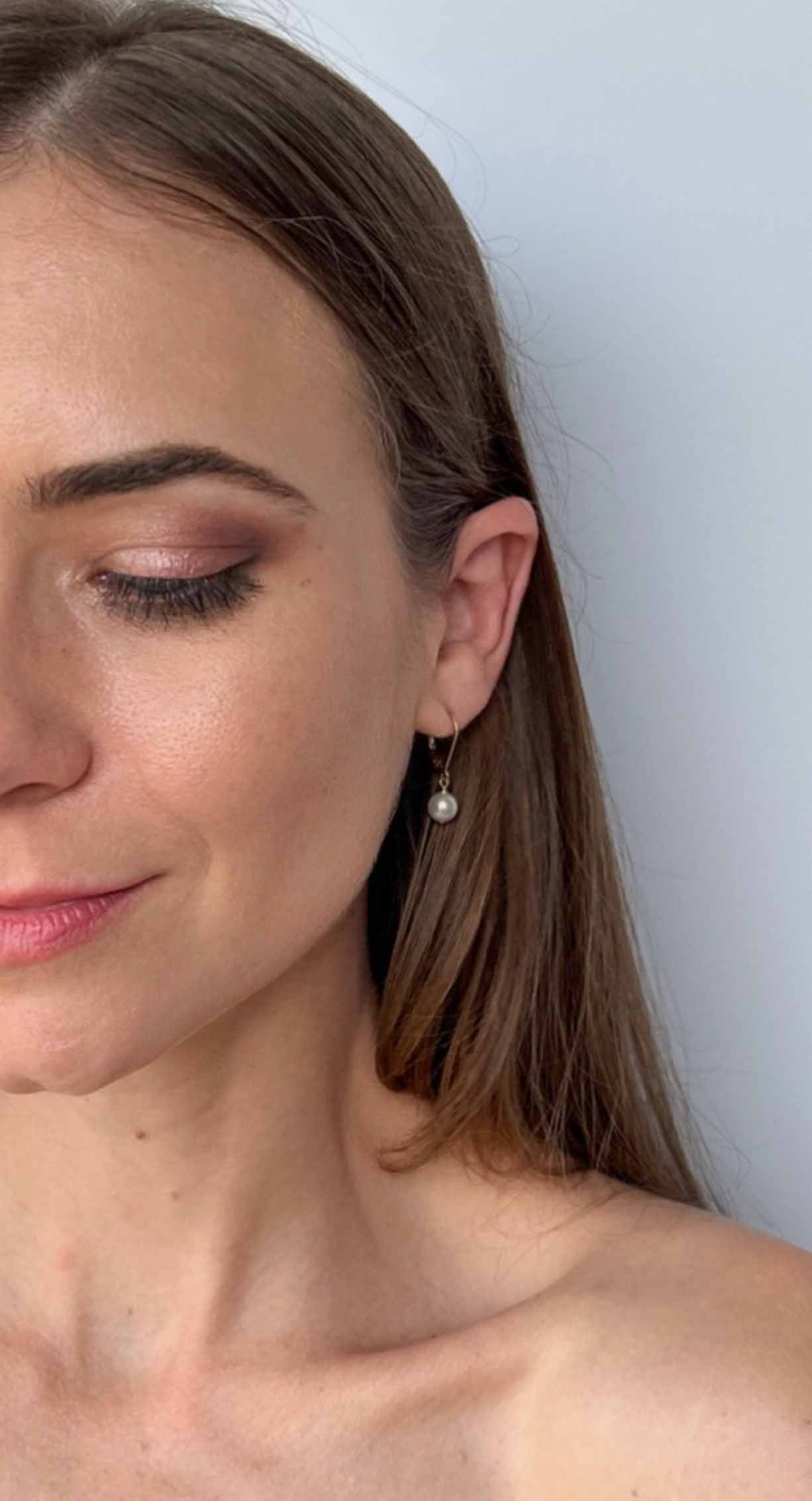 model wearing Lucia leverback pearl earrings