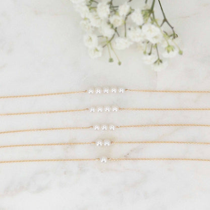 Lucia Add A Pearl Necklace showing the look of 1 to 5 pearls on a 14k gold filled chain