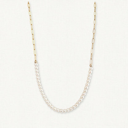 modern paperclip chain necklace with drape of freshwater pearls on offwhite background