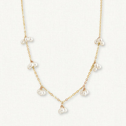 Pearl cluster necklace in gold, close up