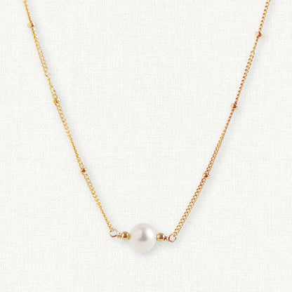 gold satellite chain with center pearl on white background.  14k gold filled or sterling silver chain with single pearl necklace