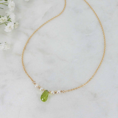 close up of peridot and pearl necklace