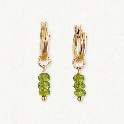 Gold hoop earrings with peridot gemstone dangles