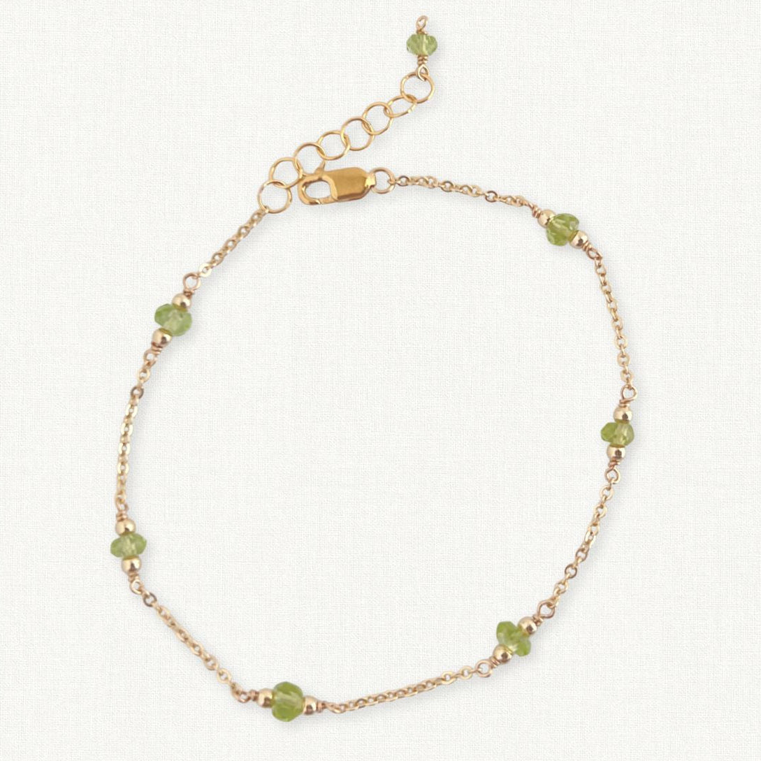 Peridot Gemstone Bracelet in 14k gold filled on beige background