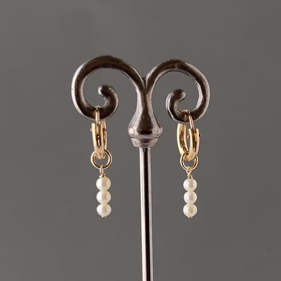 360 video of pearl huggie earrings