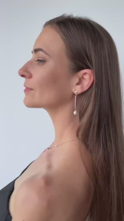video of model in pearl necklace with matching earrings