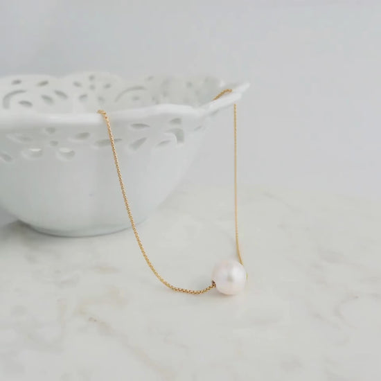 Big Pearl Necklace shown on marble surface