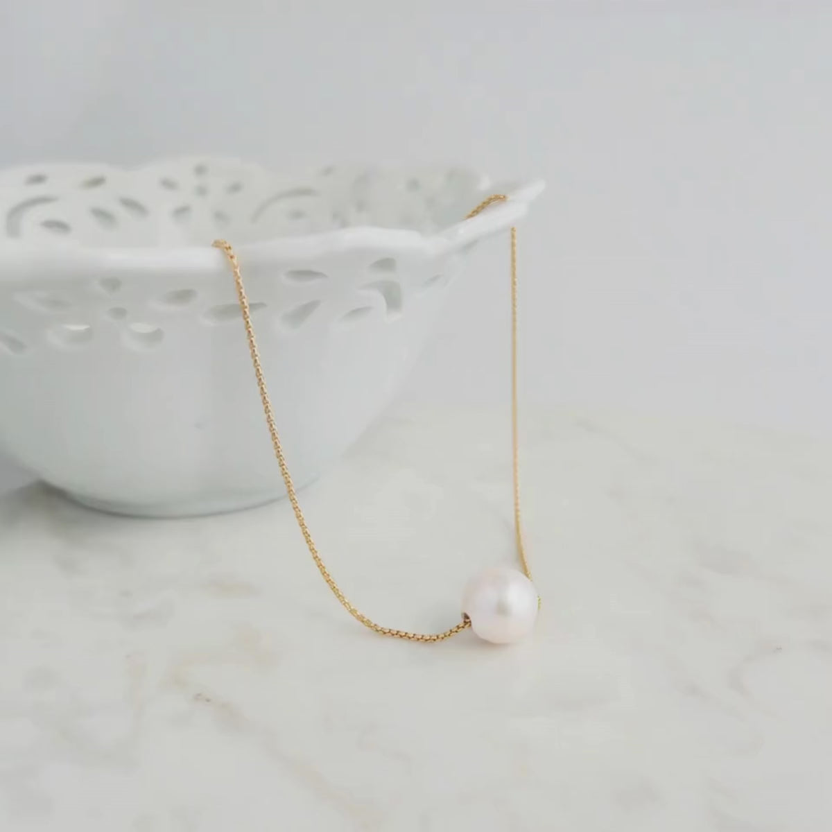 Big Pearl Necklace shown on marble surface