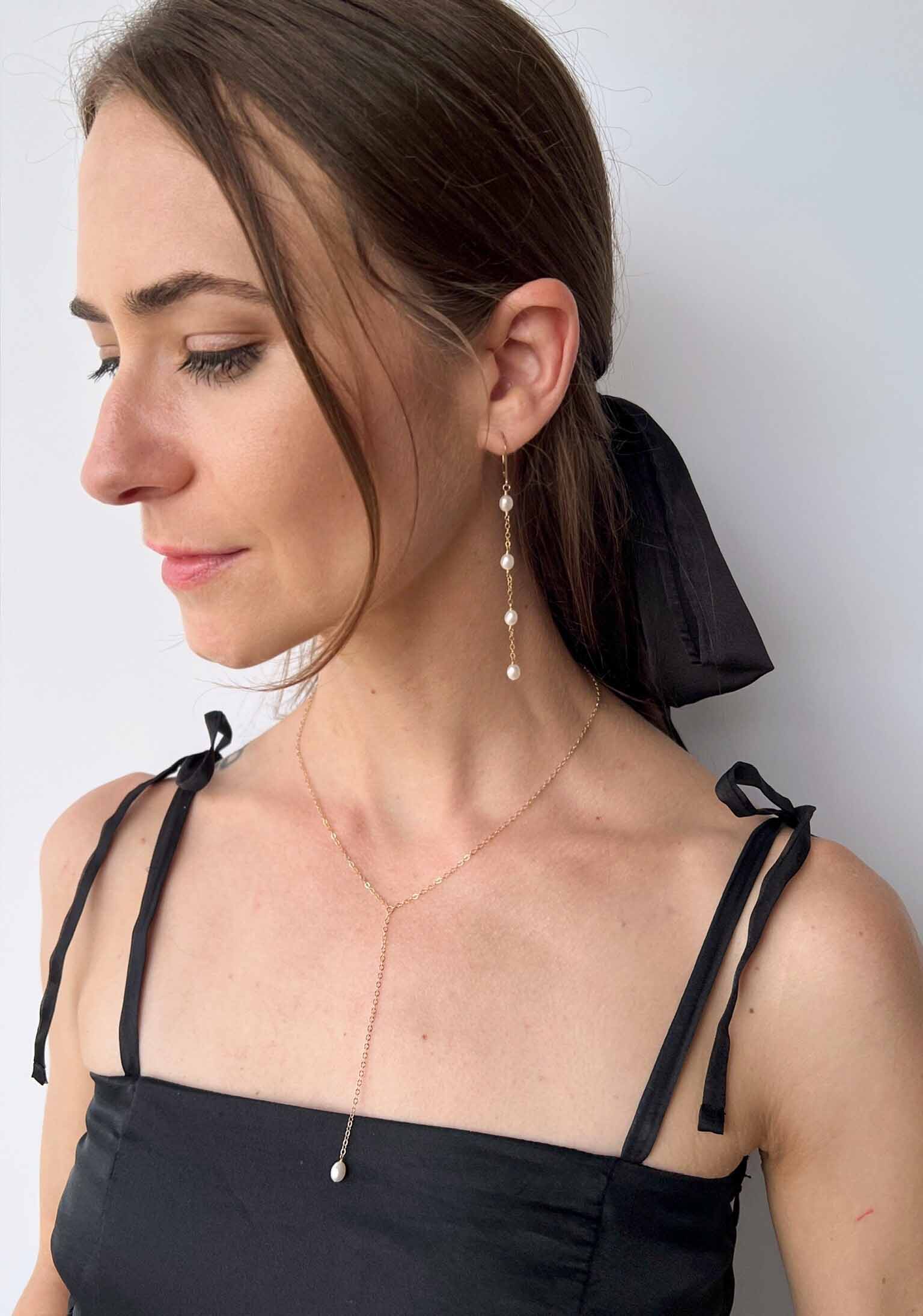 model wearing Rosa pearl earrings and lariat necklace set