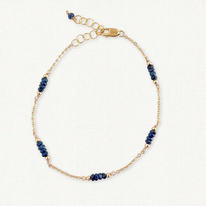 Gold Chain and Sapphire Bracelet on White Background