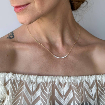 close up of Gigi mini pearl necklace on model in 14k gold fill