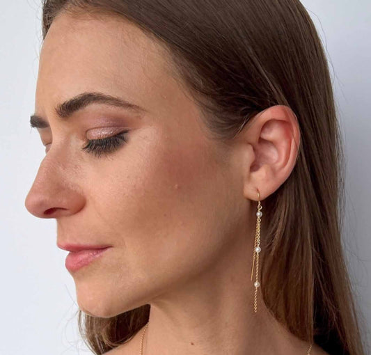 model wearing Gigi Long Pearl Earrings with matching pearl station necklace