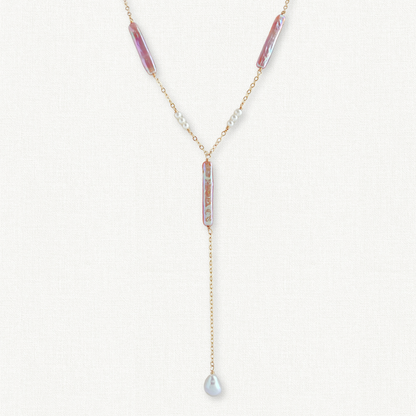 close up of pearl lariat necklace with pink biwa pearls and tiny white pearls