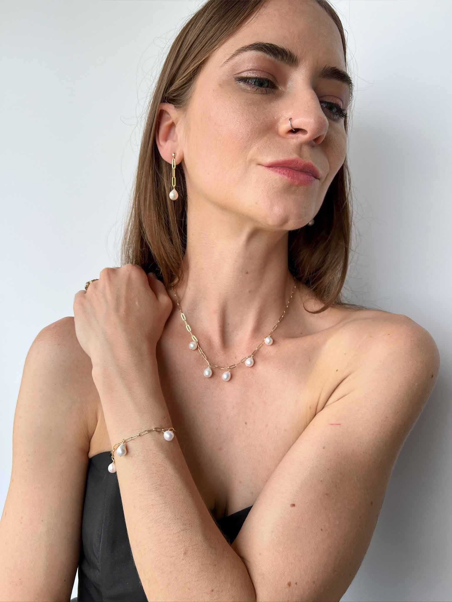 model wearing matching set of necklace, bracelet and earrings from the Vivara Collection of baroque pearls