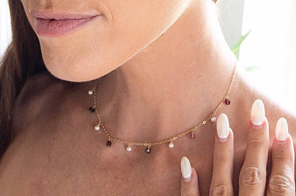 close up of model wearing tourmaline gemstone dangle necklace