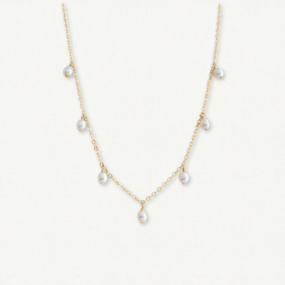 Pearl necklace with gold chain on a white background