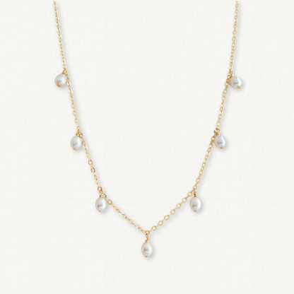 close up of pearl dangle necklace in 14k gold filled
