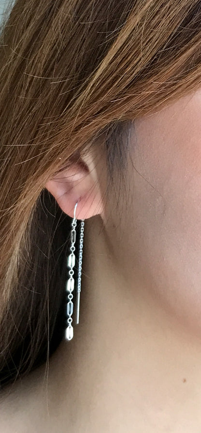 close up of model wearing sterling silver long chain threader earrings