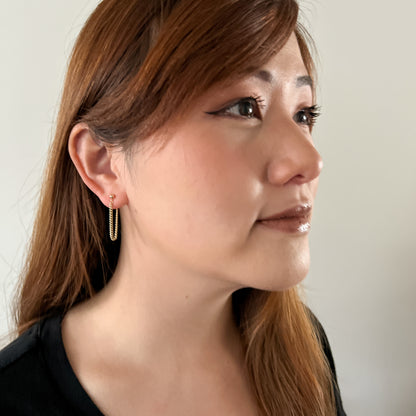model wearing 14k gold filled curb chain earrings